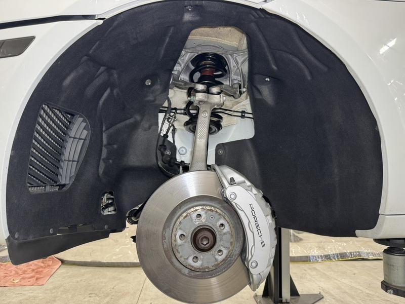Front wheel well after dry ice cleaning, brake caliper and suspension exposed